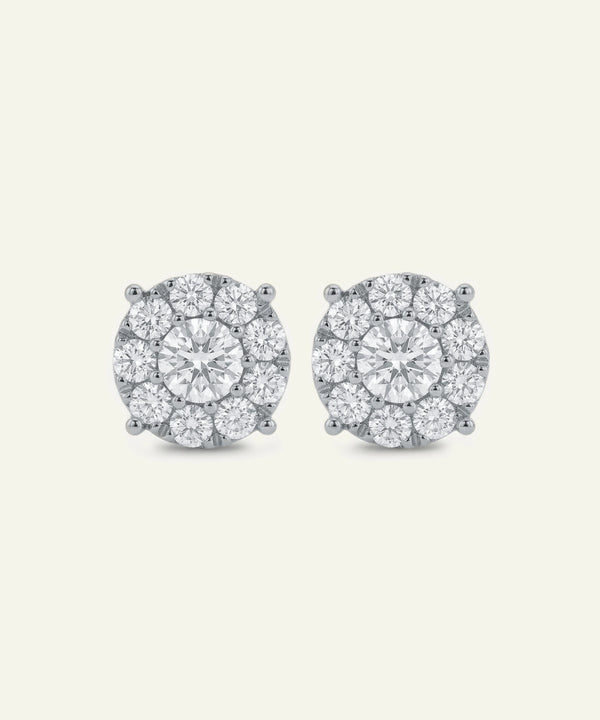 Pair of diamond stud earrings on a light gray background