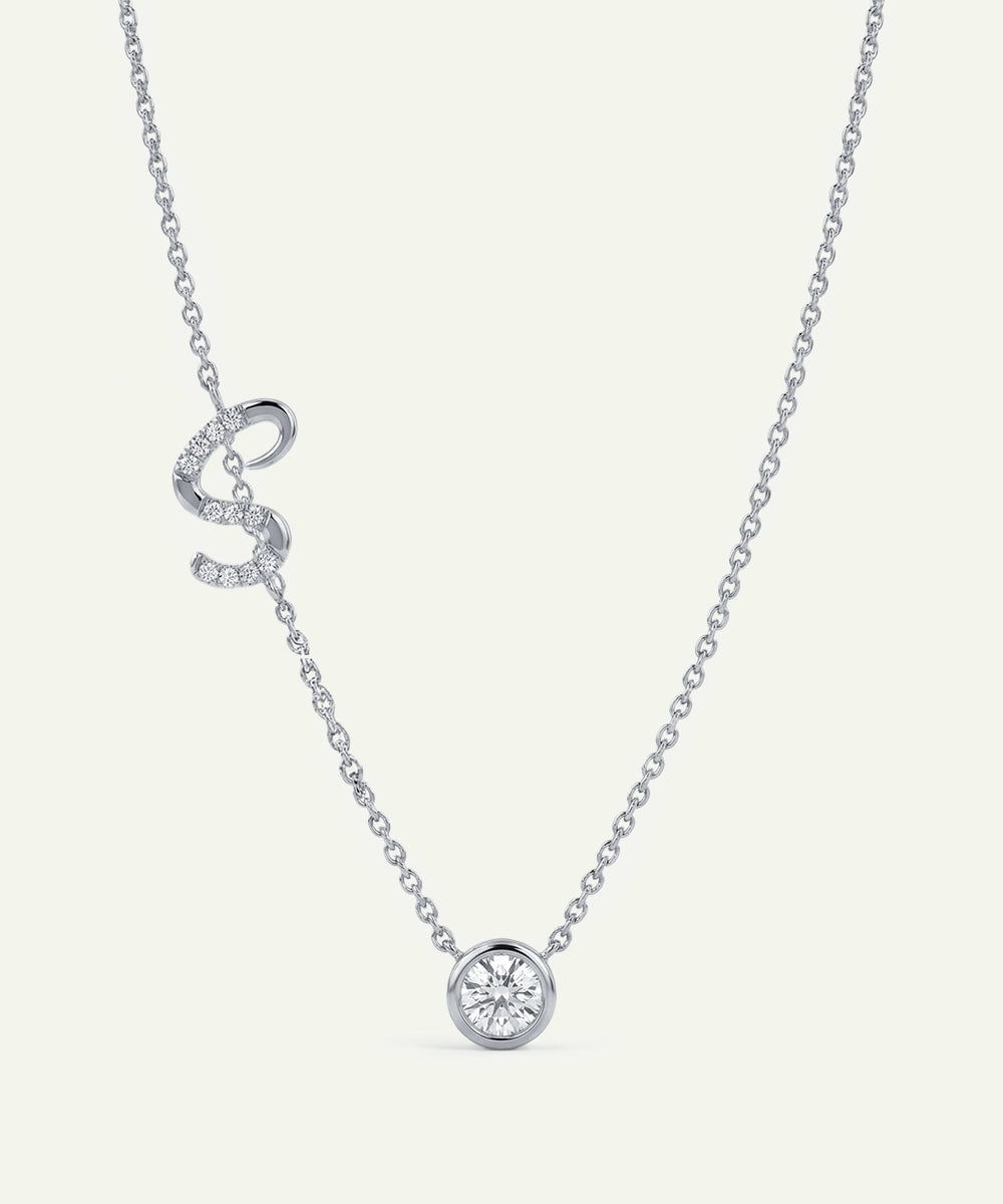 Silver necklace with a heart-shaped pendant on a white background