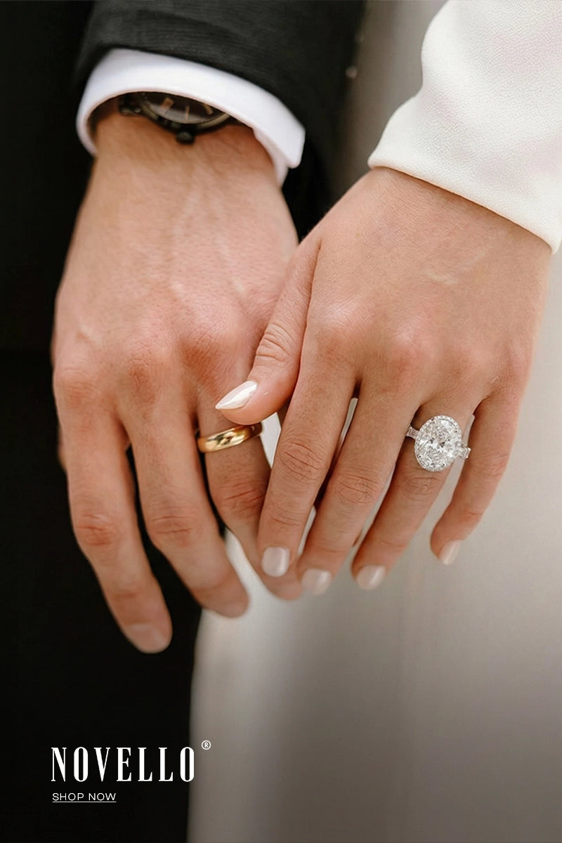 Close-up of two hands with gold and diamond rings, featuring the Novello brand.