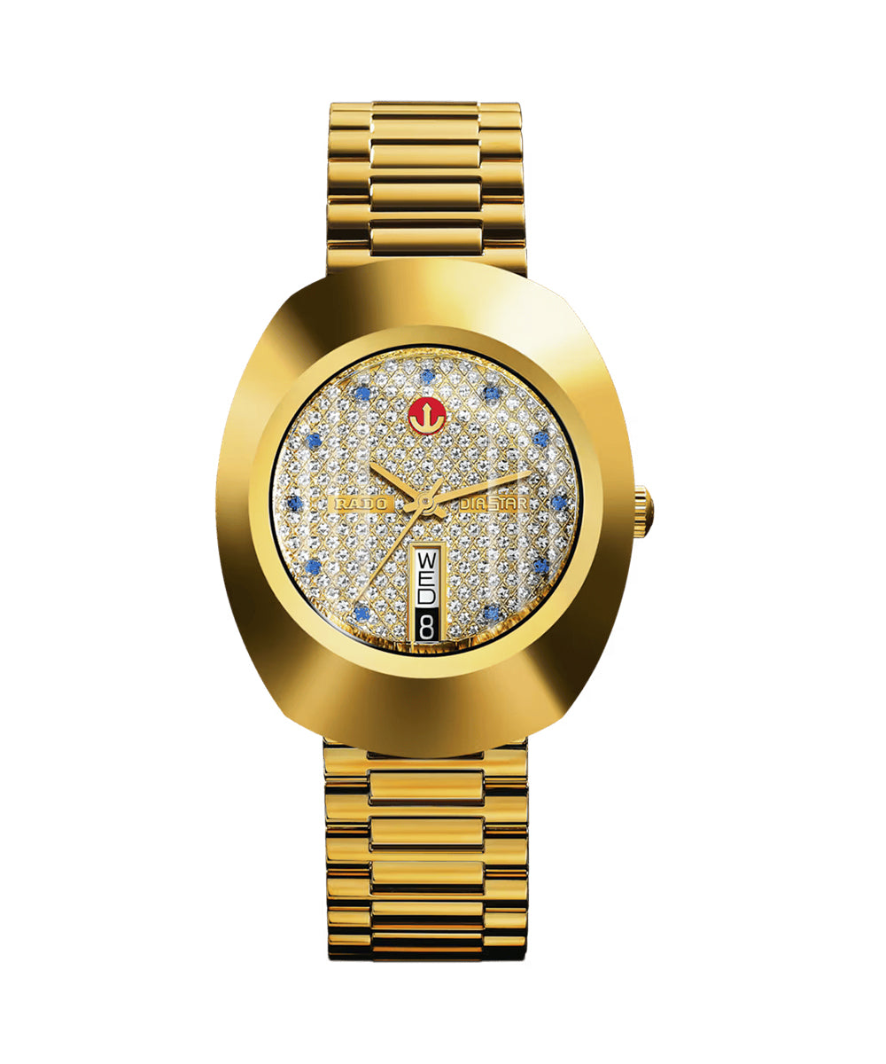 Gold wristwatch with a decorative face on a white background