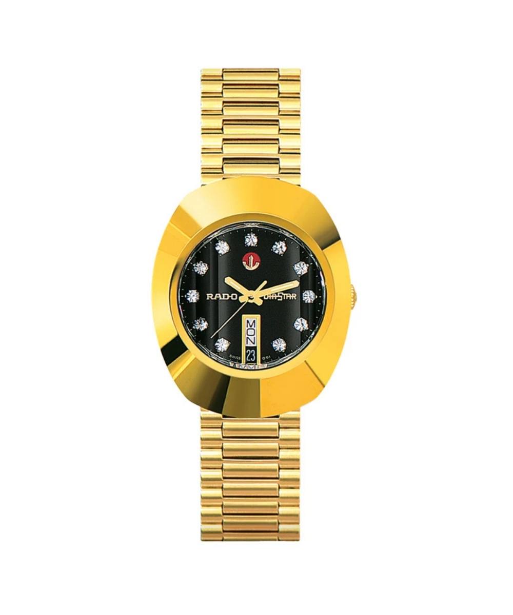 Gold wristwatch with a black face on a white background