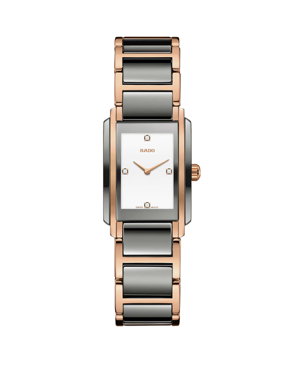 Watch with a rectangular face and rose gold and silver band on a white background