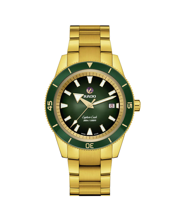 Gold watch with green bezel and black face on a white background