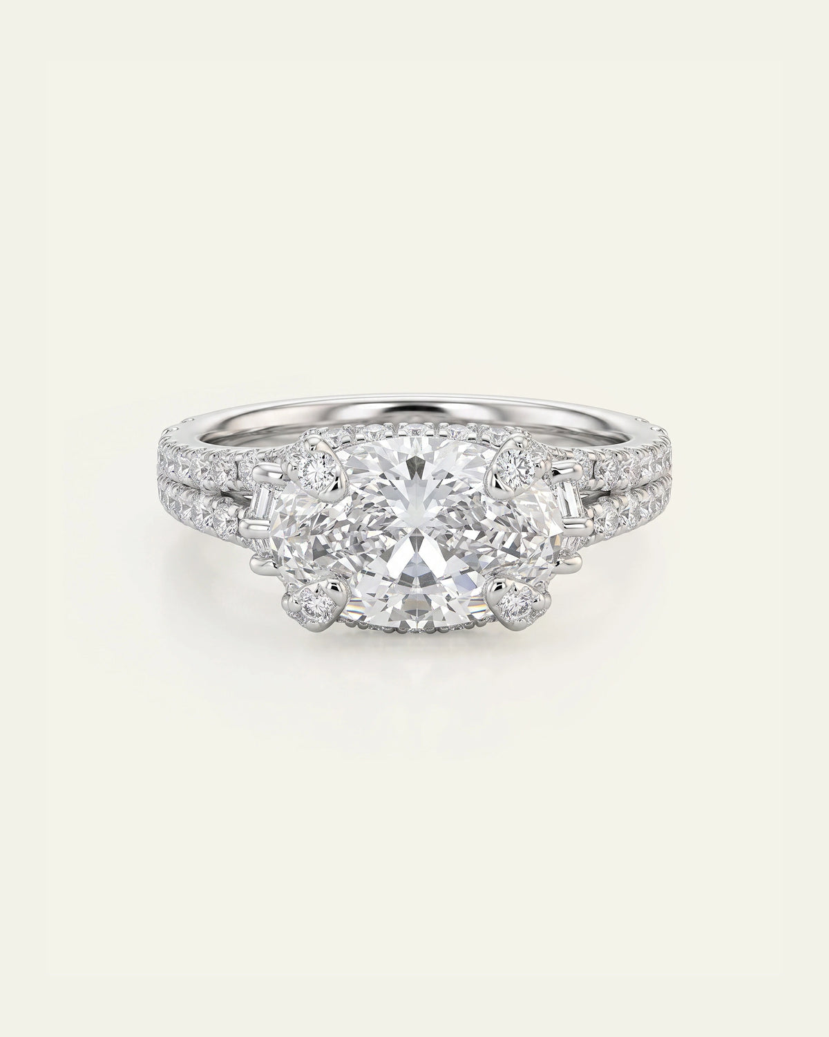 A radiant cluster diamond ring in a silver-toned metal setting, featuring a large round center stone and smaller surrounding stones on the band, photographed on a clean off-white background.