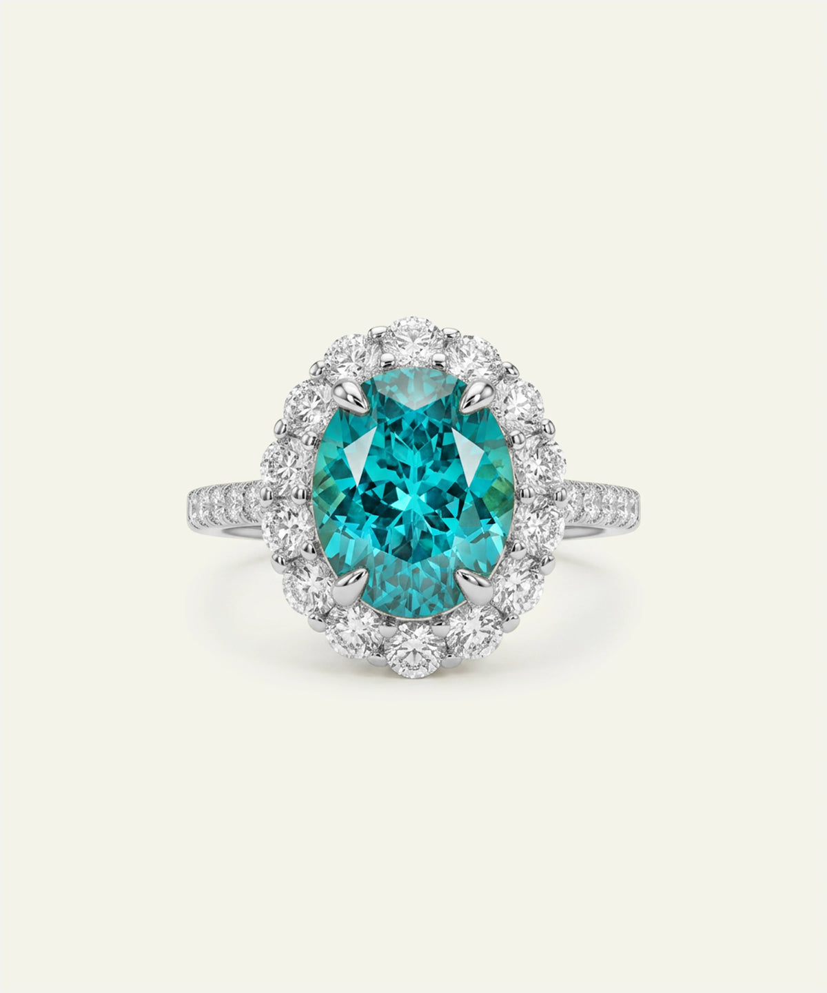 An oval-cut turquoise gemstone halo ring in a silver-toned setting, surrounded by a halo of small clear stones, on a light cream background.