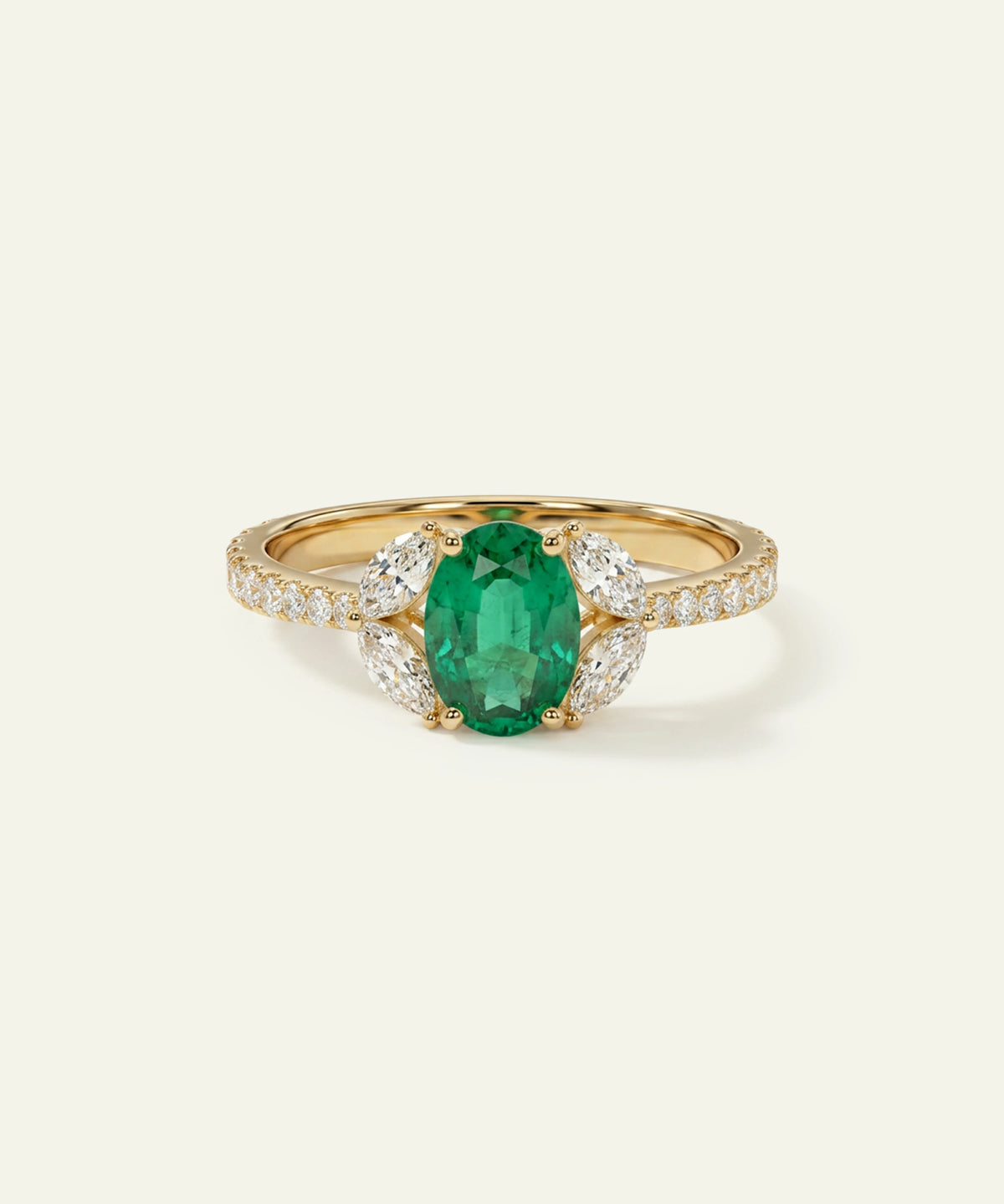 A yellow gold ring featuring a prominent oval-cut green emerald center stone, accented by small clear pavé diamonds on the shoulders and a diamond-encrusted halo on the sides, set against a solid off-white background.