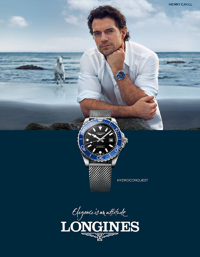 Man in a white shirt with a watch, Longines advertisement with ocean background
