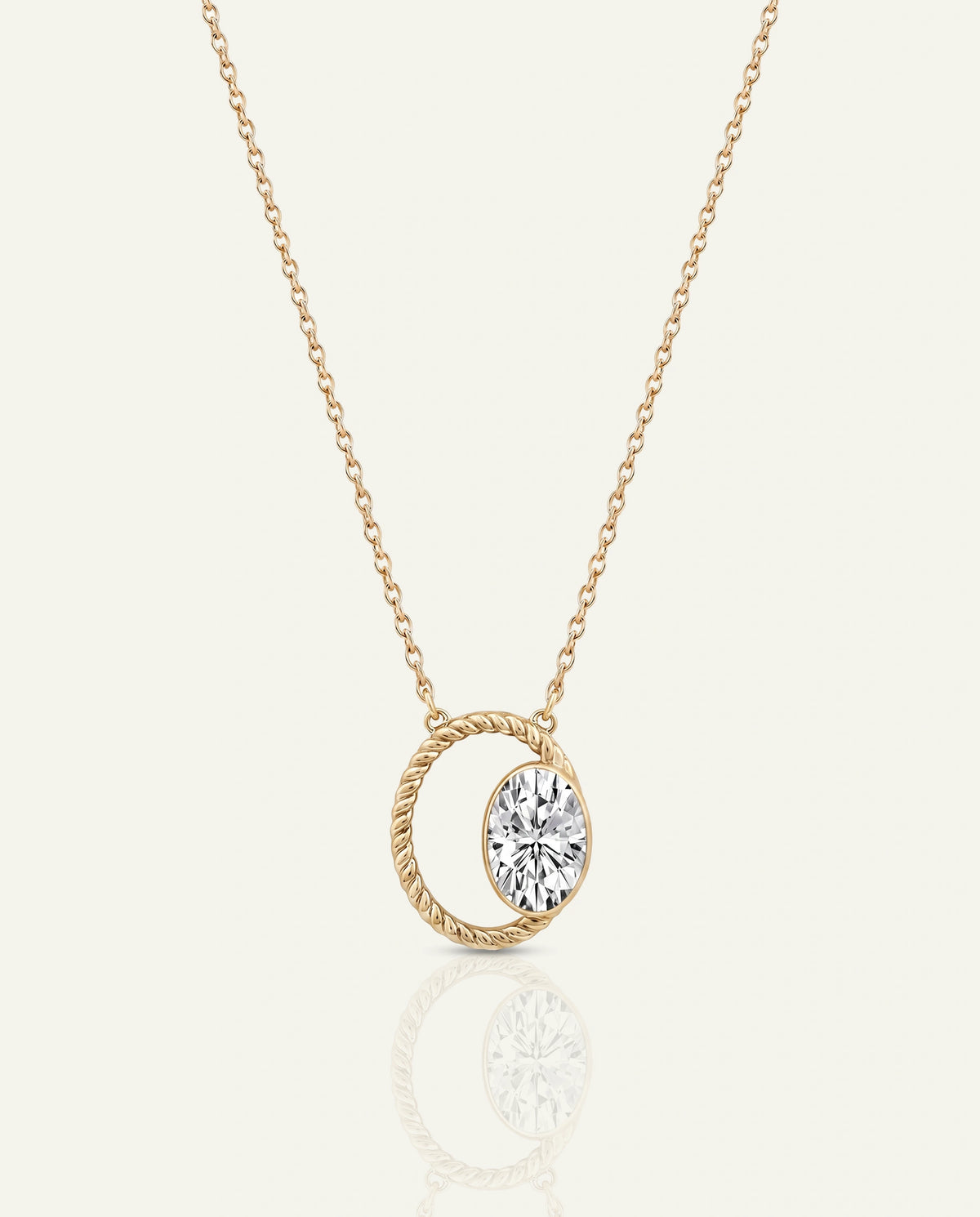 A silver chain necklace featuring a geometric drop pendant with an elongated emerald-cut blue-green gemstone and a diamond-shaped accent, set against a light cream background
