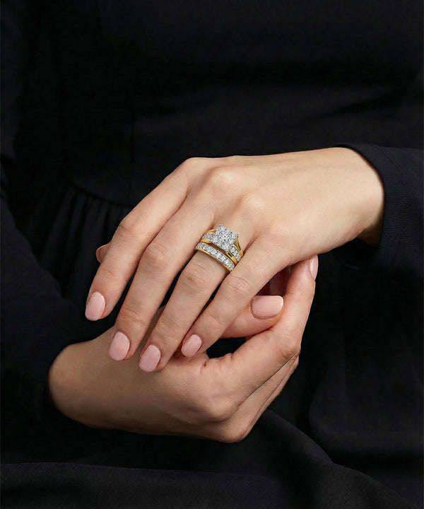 Close-up of hands with diamond rings on a dark background