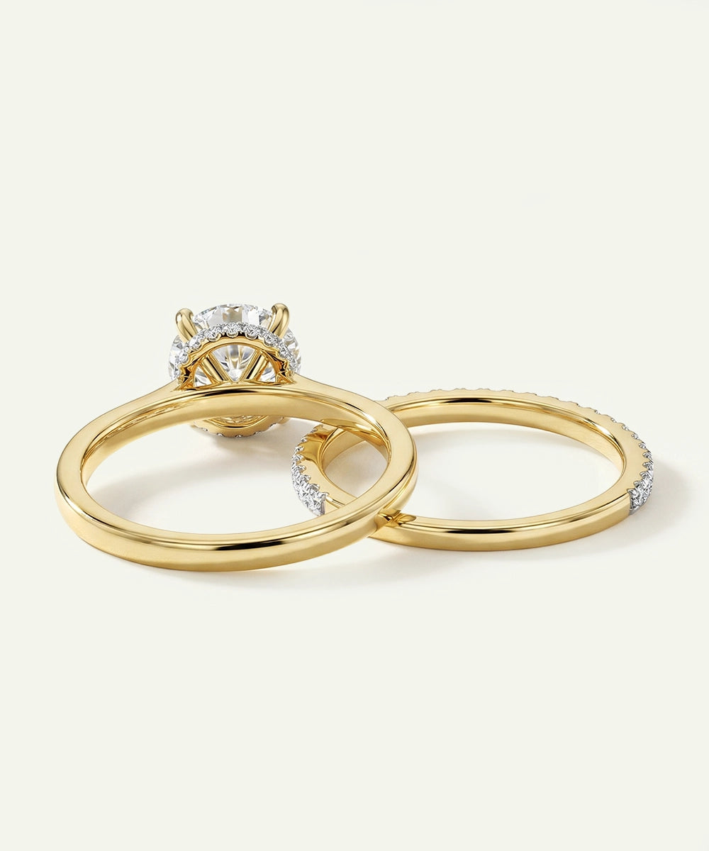 Two gold rings with diamond accents on a light gray background