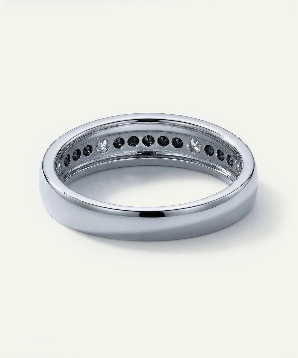 Silver ring with embedded stones on a white background
