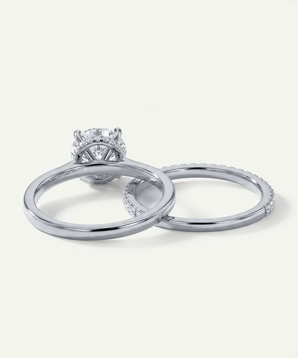 Two silver rings with a diamond on a white background
