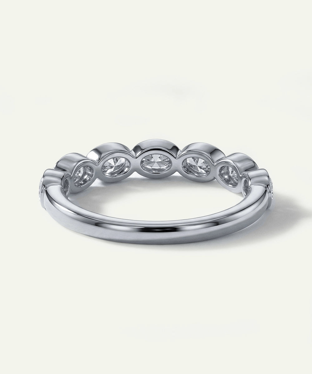 Silver ring with five diamonds on a white background