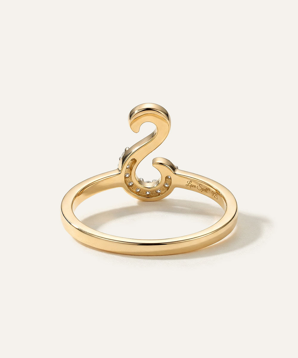 Gold ring with a unique design on a white background