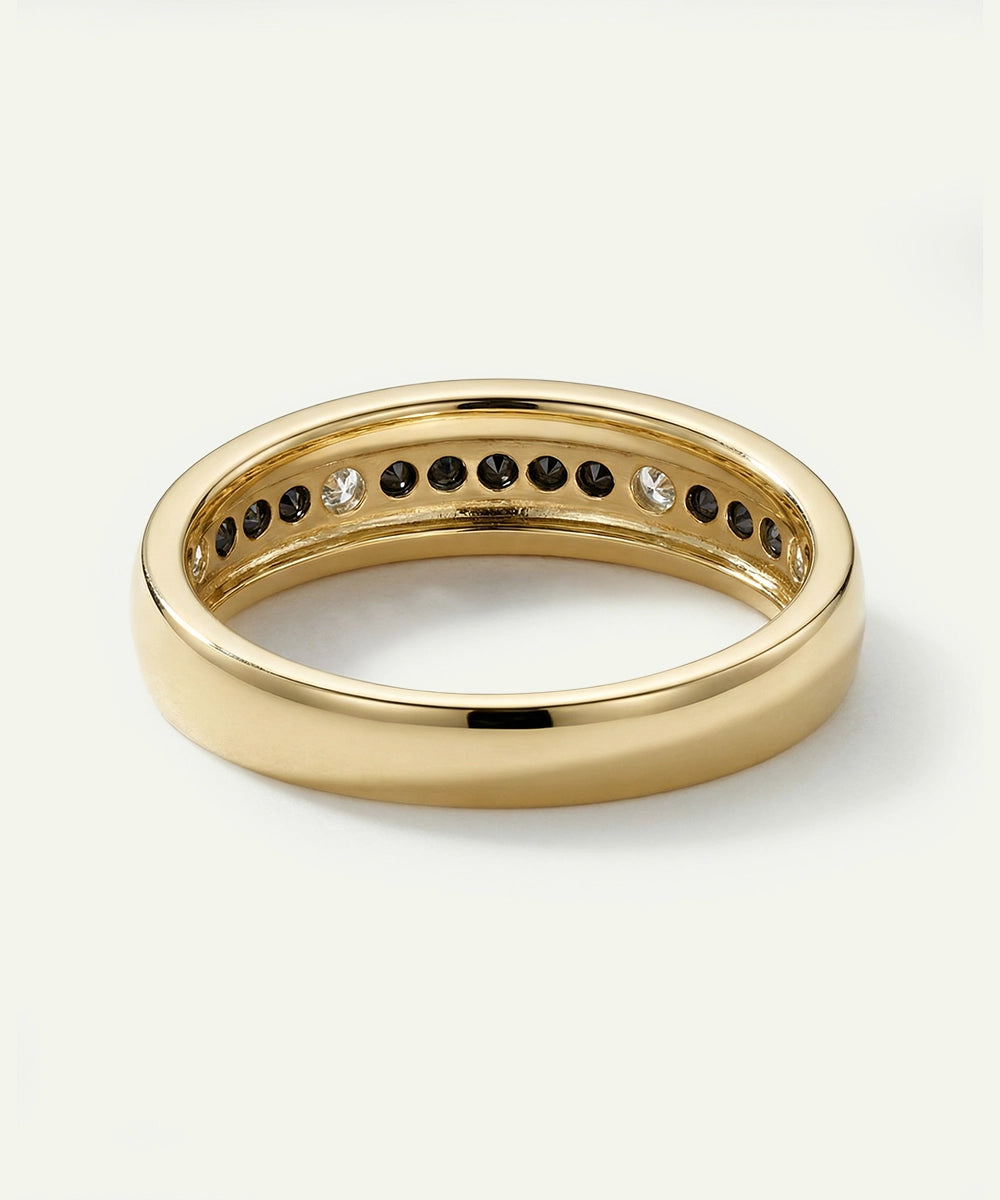 Gold ring with embedded stones on a white background