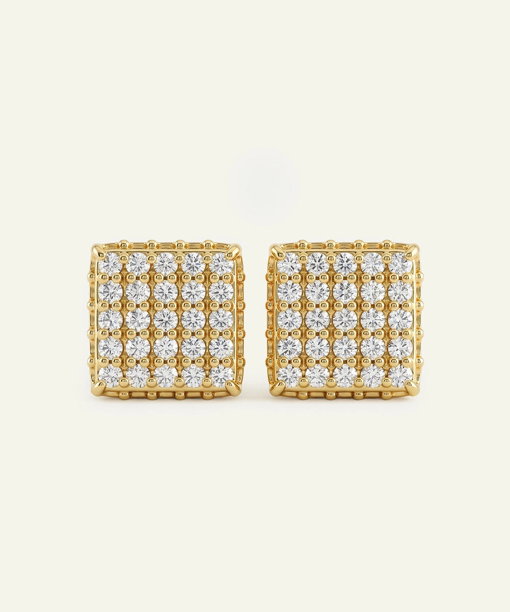 Gold square earrings with clear gemstones on a white background
