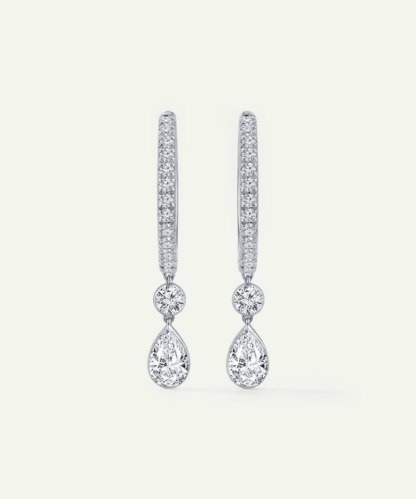 Pair of diamond earrings on a light gray background