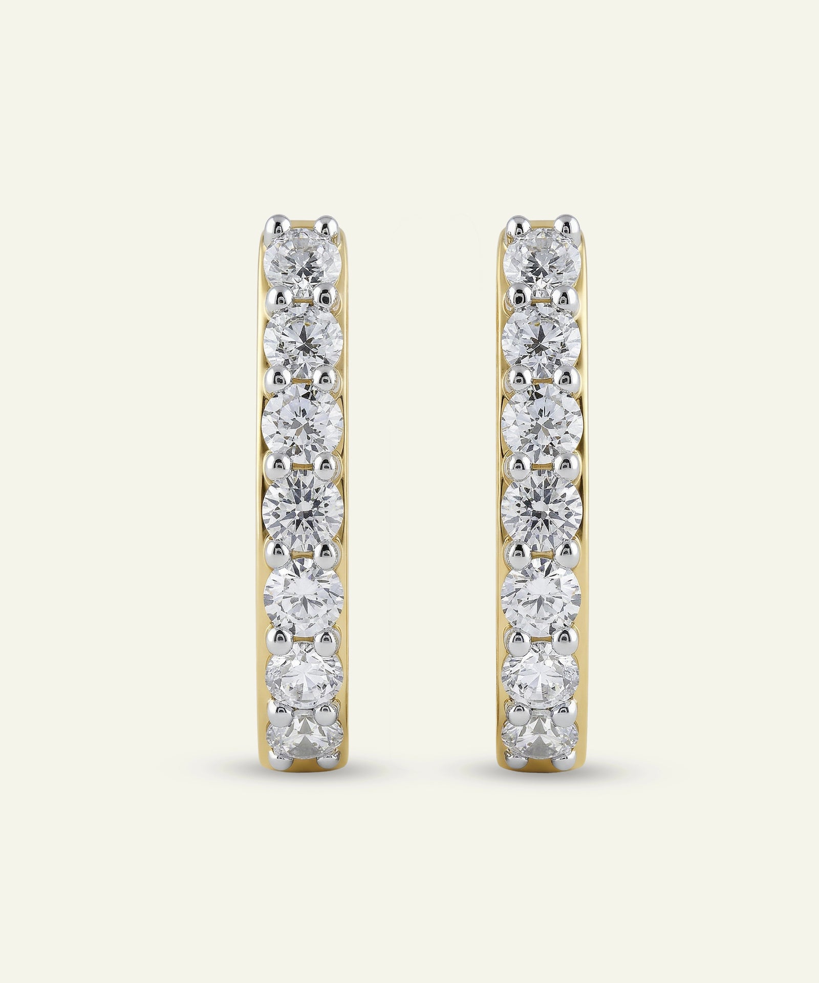 Pair of diamond hoop earrings on a white background