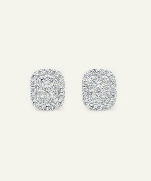 Pair of silver earrings with a textured design on a light gray background