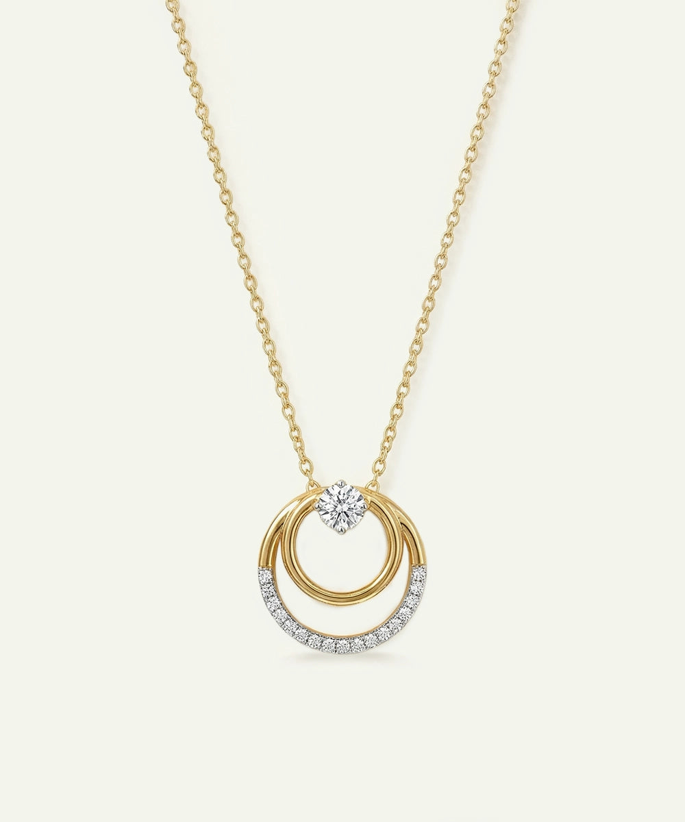 Gold necklace with a circular pendant on a white background