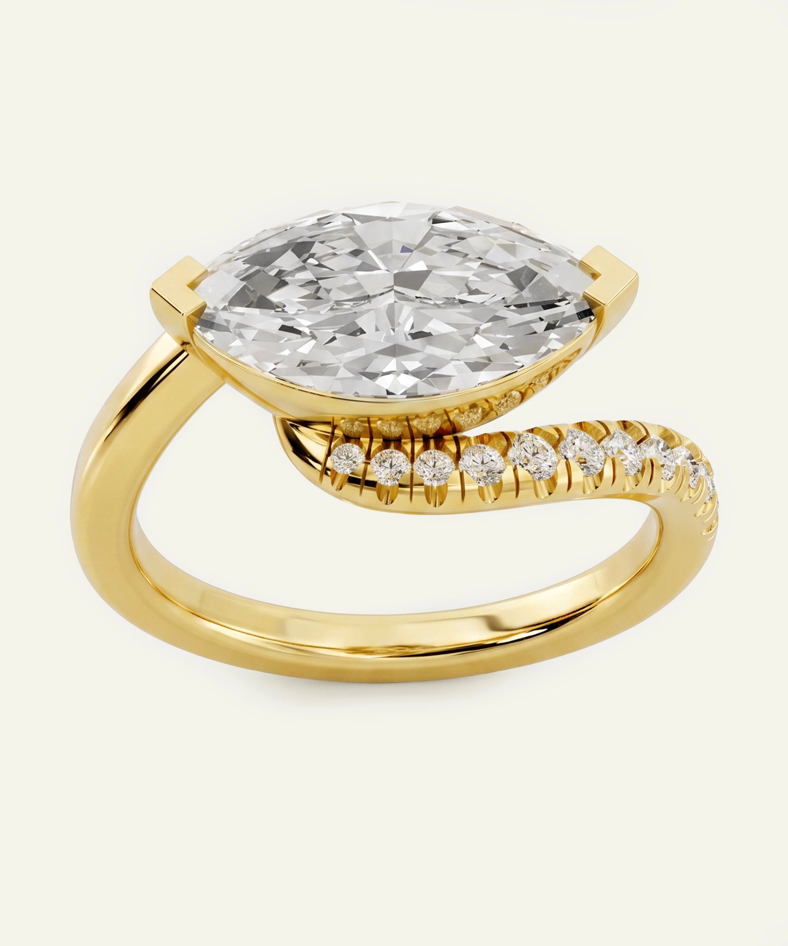 Gold ring with a large diamond and smaller diamonds on the band against a white background