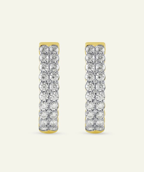 Pair of gold and diamond earrings on a white background
