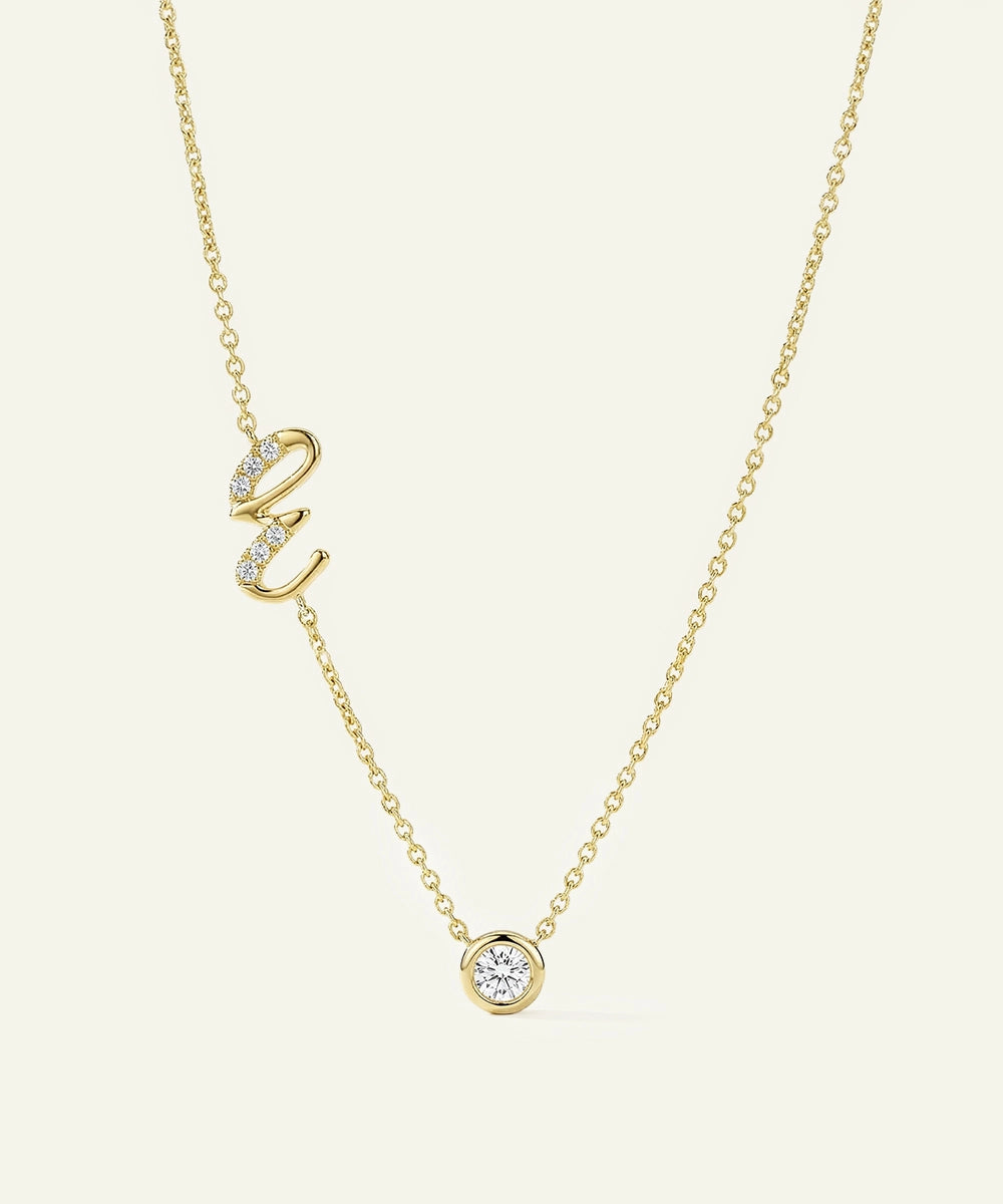 Gold necklace with diamond pendants on a light beige background