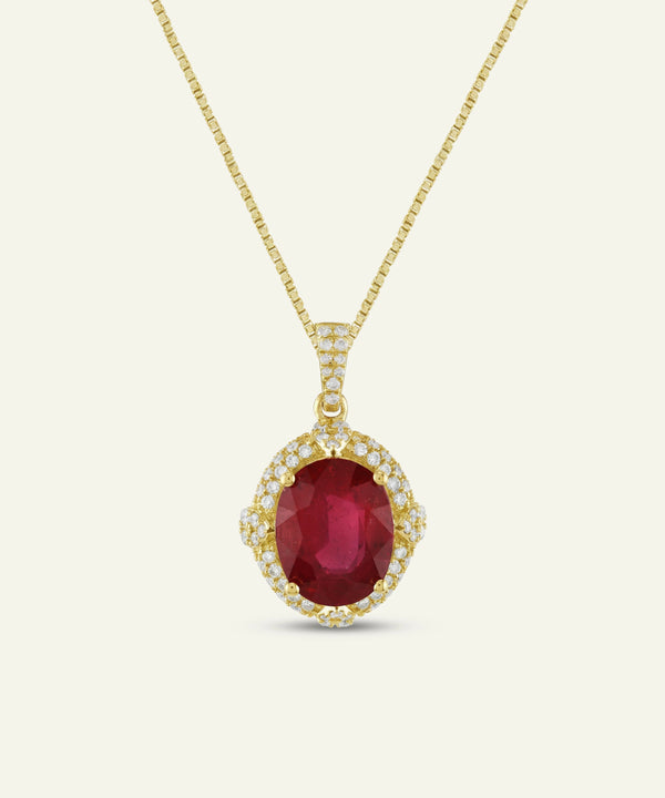 Oval ruby halo pendant necklace on a yellow gold chain.