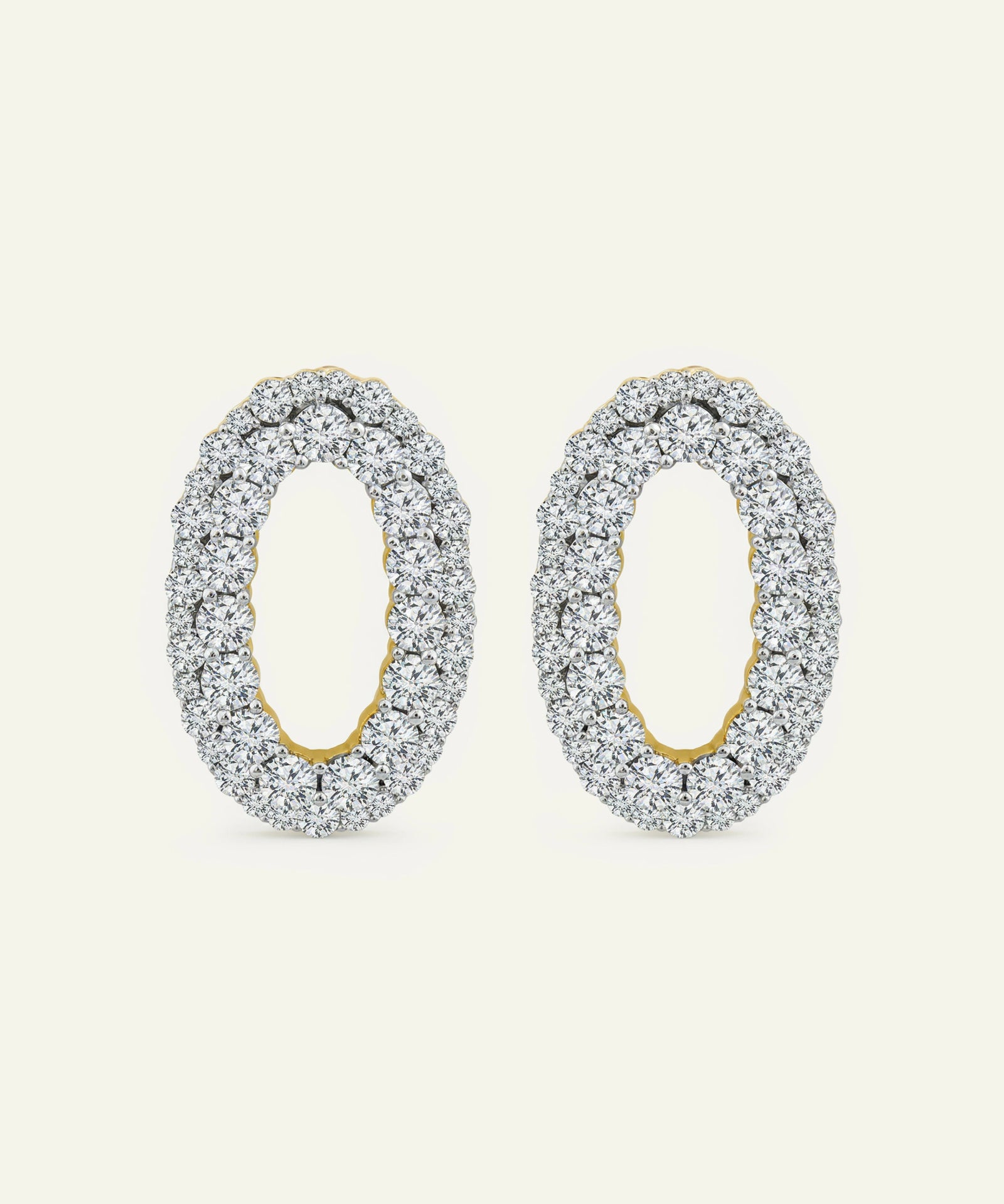 Pair of silver hoop earrings with gold accents on a white background