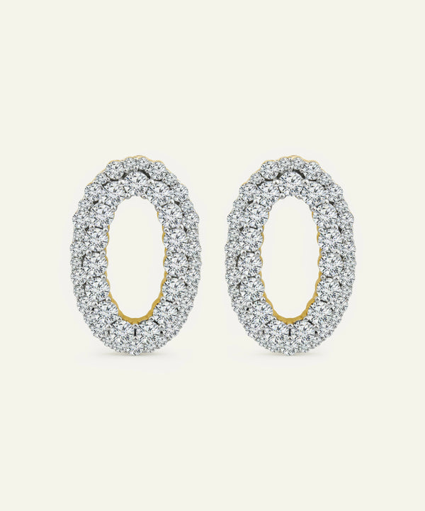 Pair of silver hoop earrings with gold accents on a white background