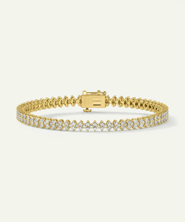 Gold bracelet with diamond accents on a white background