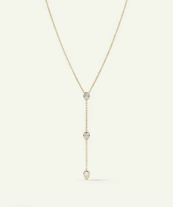 Gold necklace with diamond pendants on a white background
