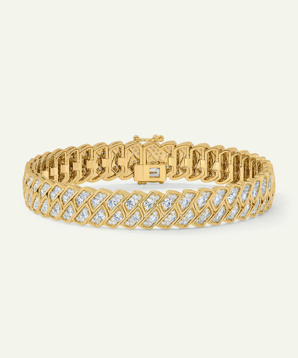 Gold bracelet with diamond accents on a light beige background