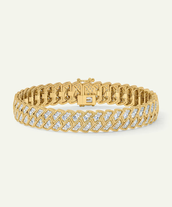 Gold bracelet with diamond accents on a light beige background