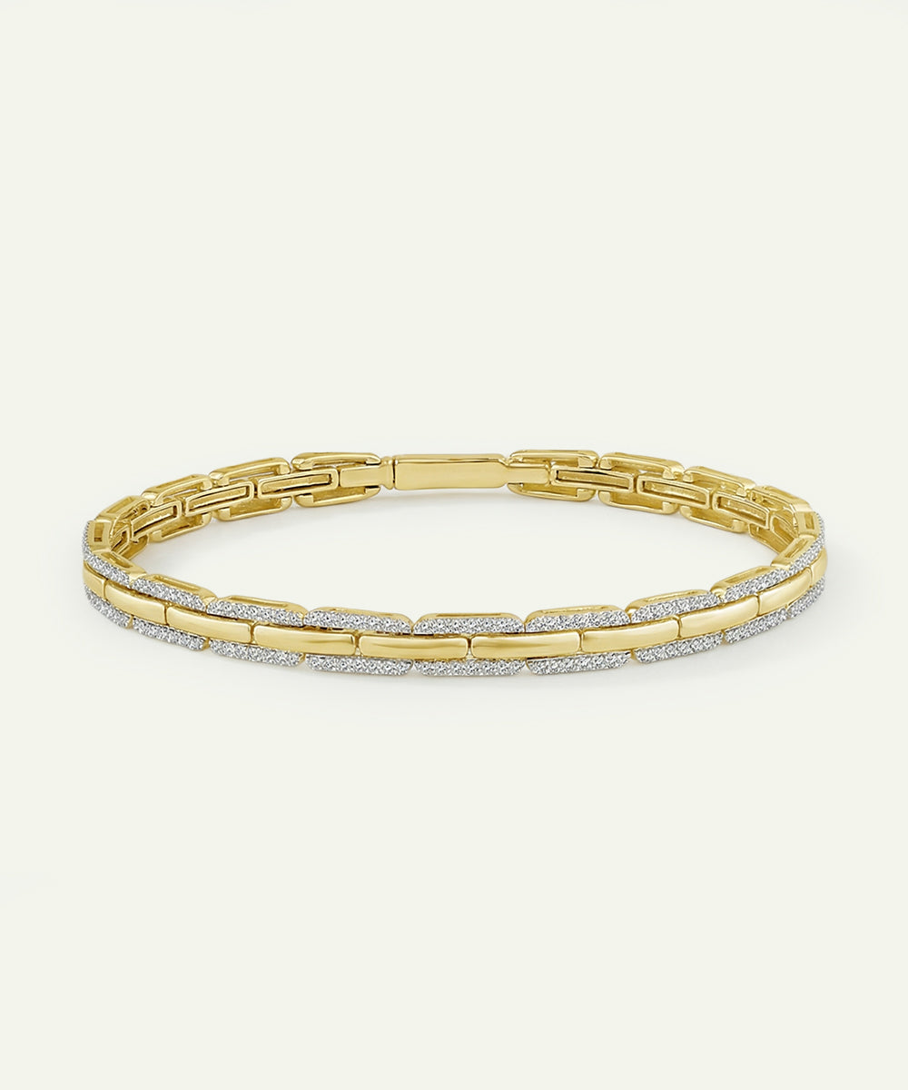 Gold bracelet with diamond accents on a white background