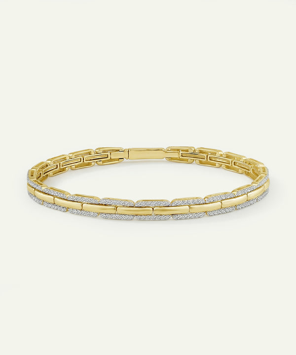 Gold bracelet with diamond accents on a white background