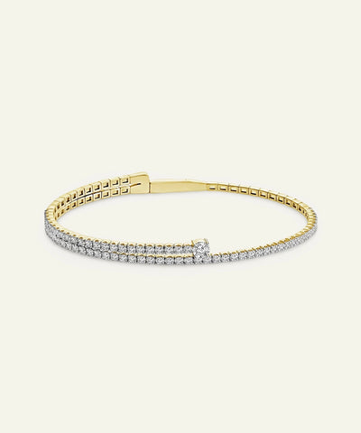 Gold bracelet with diamonds on a white background
