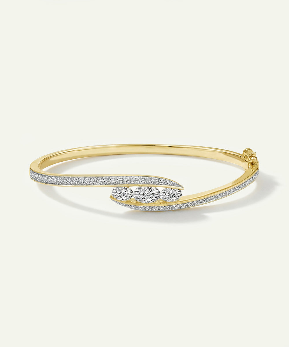 Gold bracelet with diamond accents on a white background
