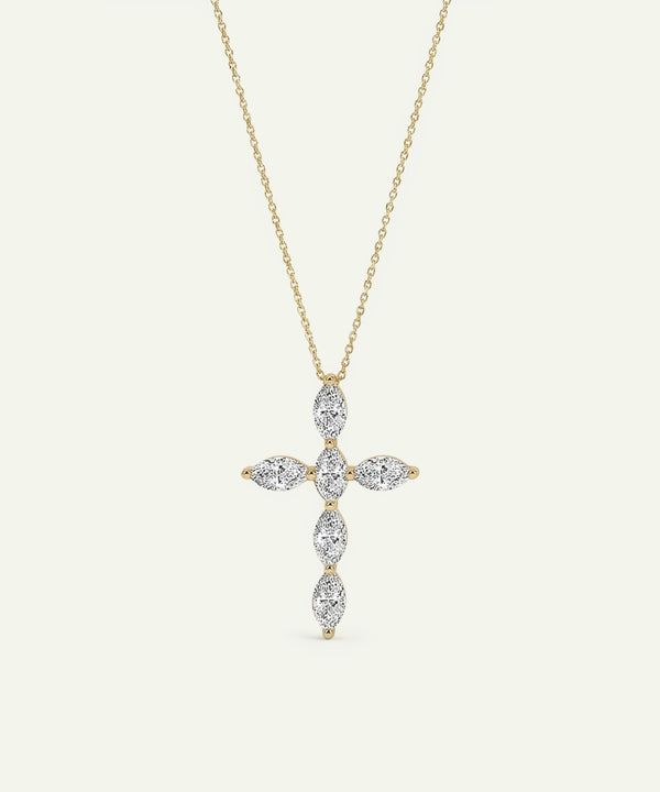 Gold cross-shaped pendant necklace with diamonds on a light beige background