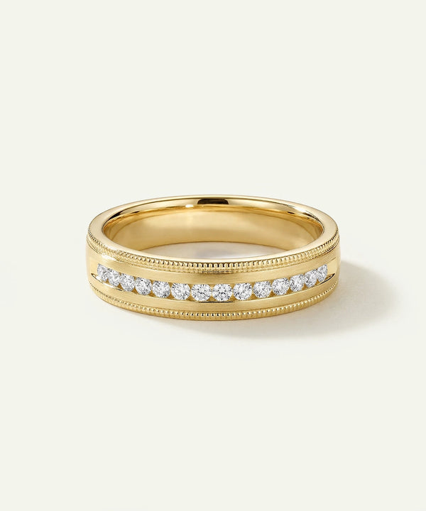 Gold ring with diamonds on a light beige background
