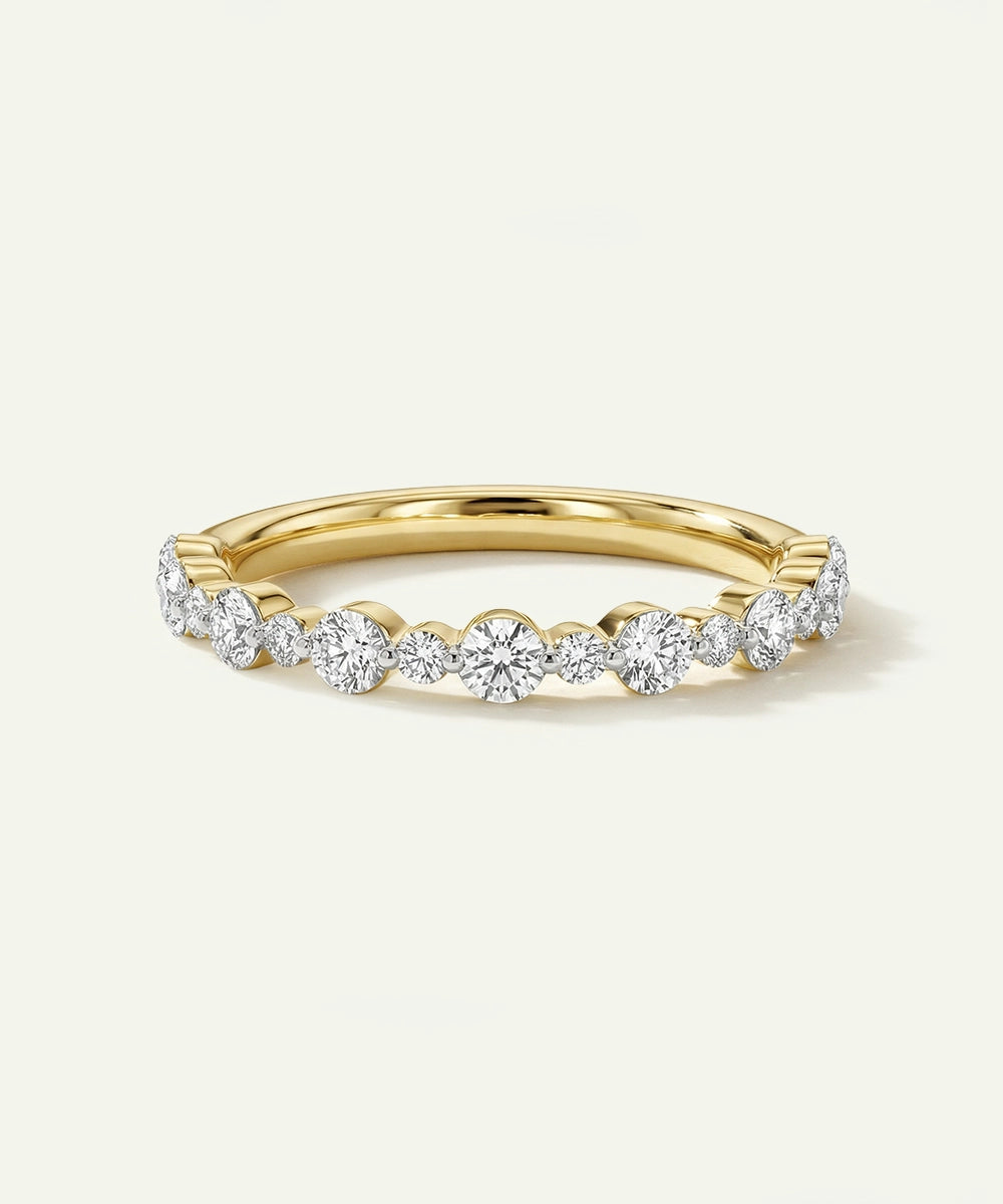 Gold ring with diamonds on a light beige background