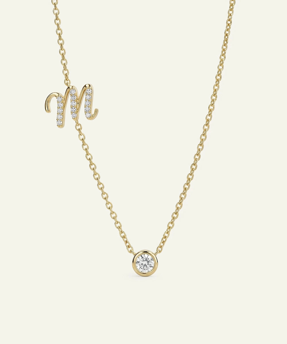 Gold necklace with a diamond pendant on a light beige background