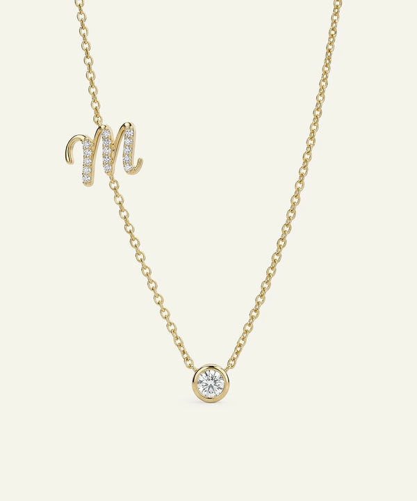 Gold necklace with a diamond pendant on a light beige background