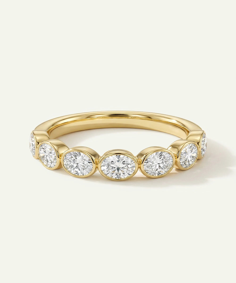 Gold ring with embedded diamonds on a light background