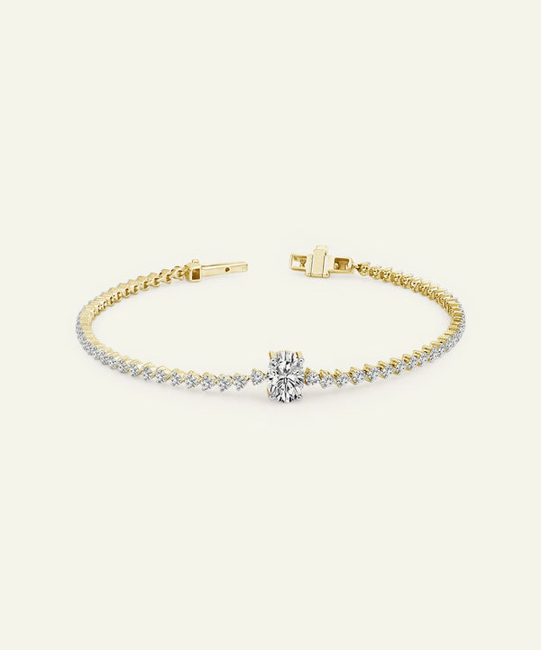 Gold bracelet with diamond accents on a white background