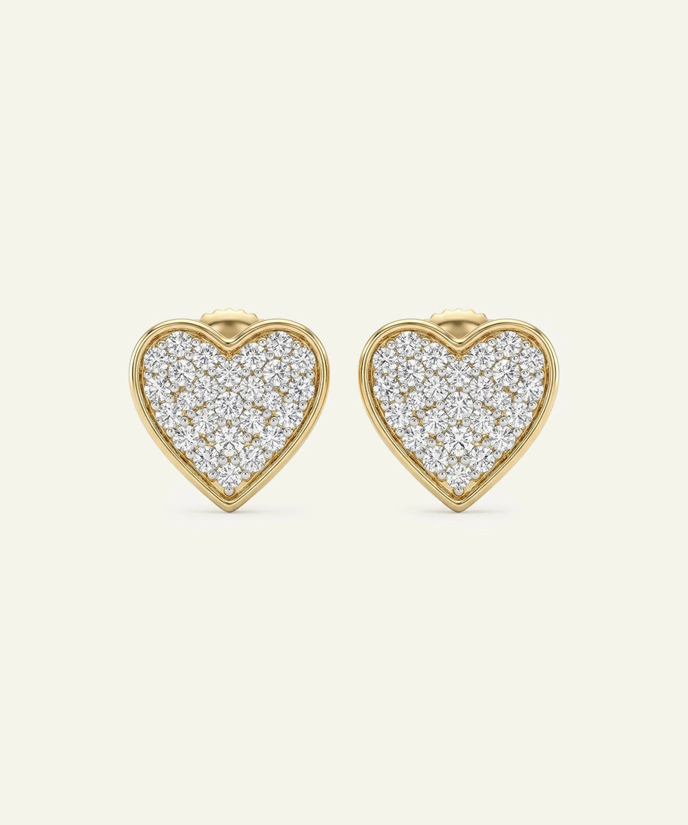 Heart-shaped earrings with diamond pavé on a white background