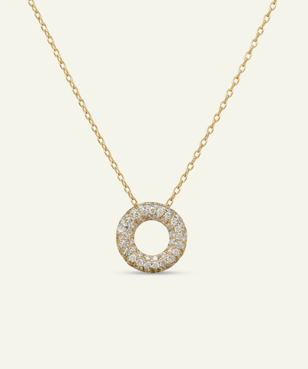 Gold necklace with a round diamond pendant on a white background