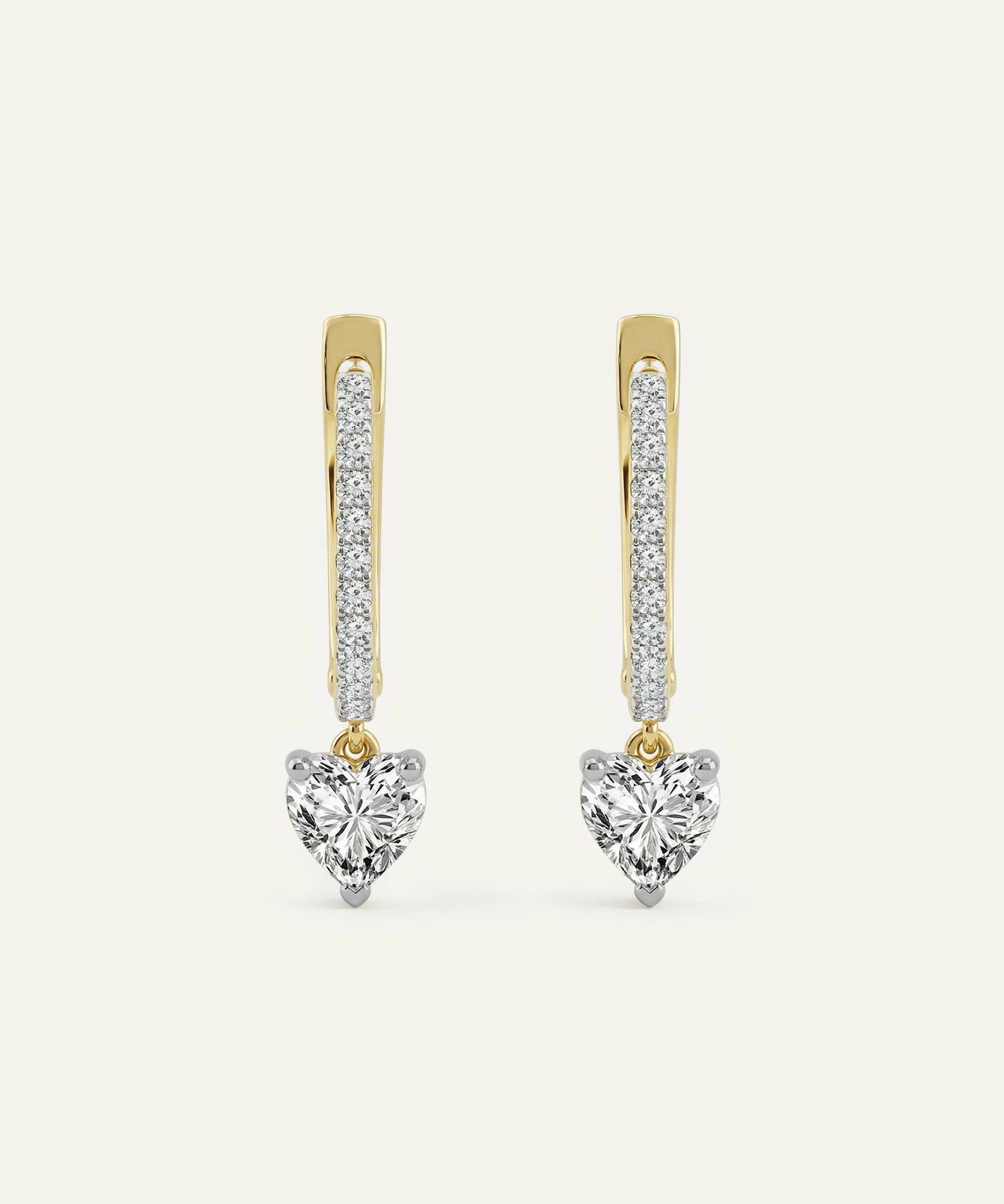Heart-shaped diamond earrings with gold and silver accents on a white background