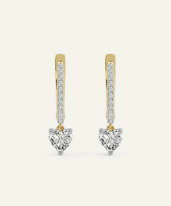 Heart-shaped diamond earrings with gold and silver accents on a white background