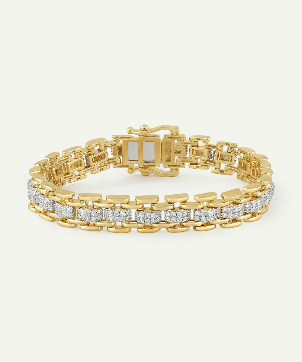Gold bracelet with diamond accents on a light beige background
